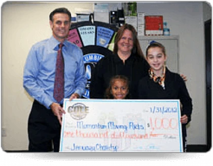 Cole Services donating 1,000 and smiling for photo