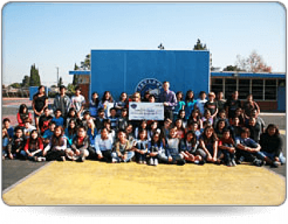 Cole Services donating to a group of children